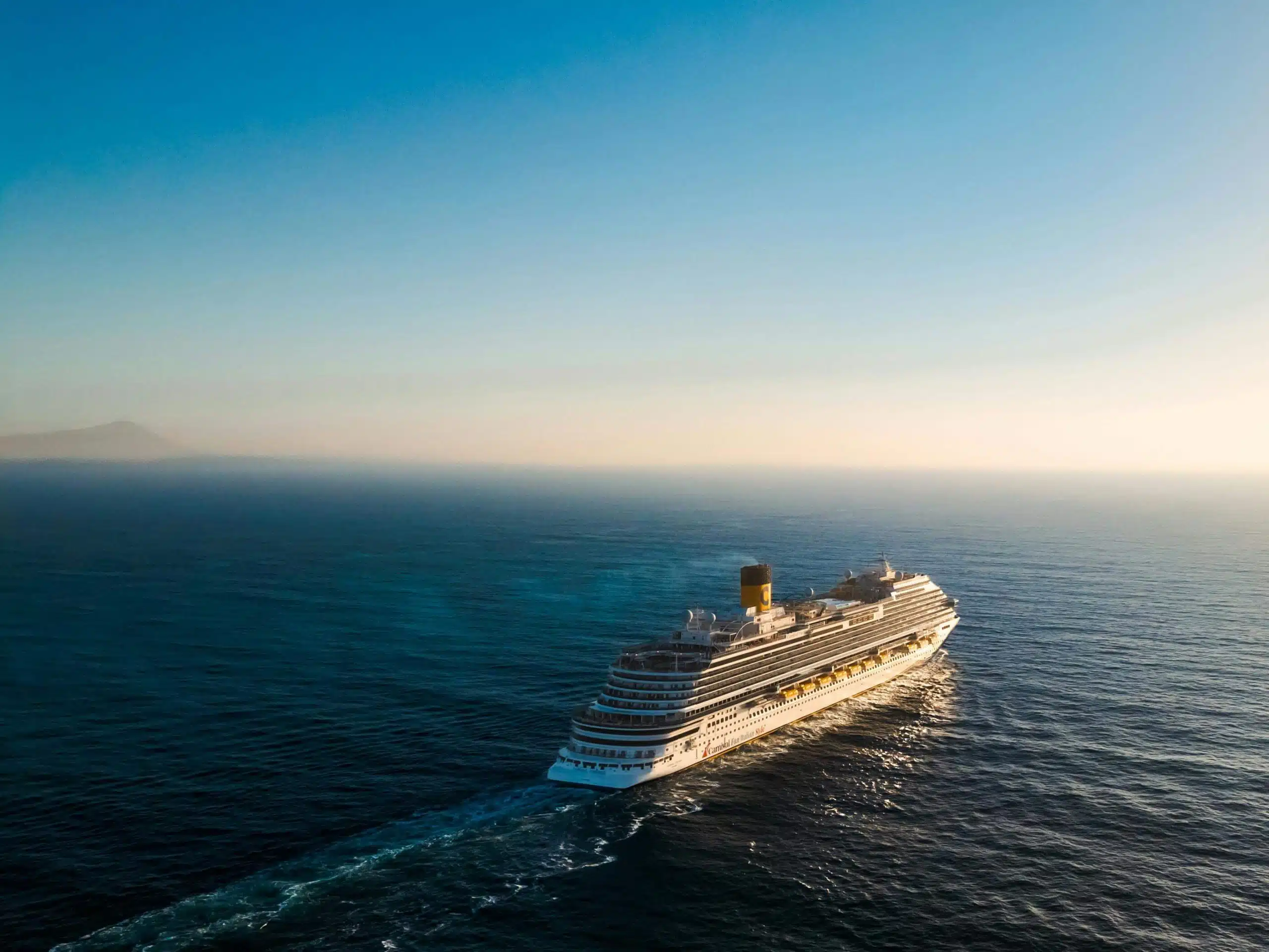 Cruise ship sailing on calm waters.
